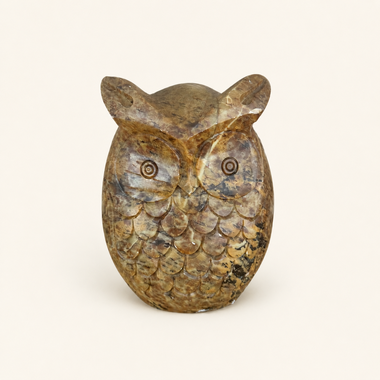 Vintage hand-carved stone owl figurine with tufted ears and incised eyes, front view