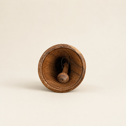 Interior of wooden hand bell showing wooden clapper