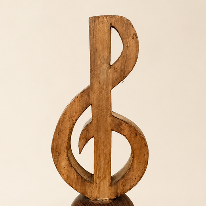 Full front view of carved wood treble clef hand bell