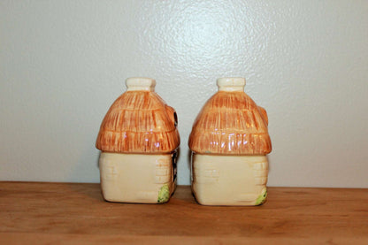 Vintage ceramic cottage salt and pepper shakers with peach thatched roofs, photo 3 of 10