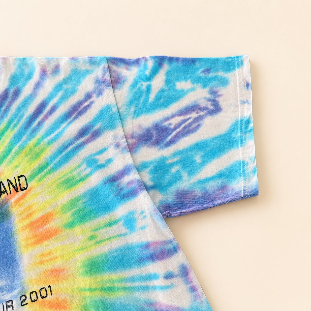 Right sleeve of vintage 2001 Dave Matthews Band tie-dye tee, blue and purple spiral dye