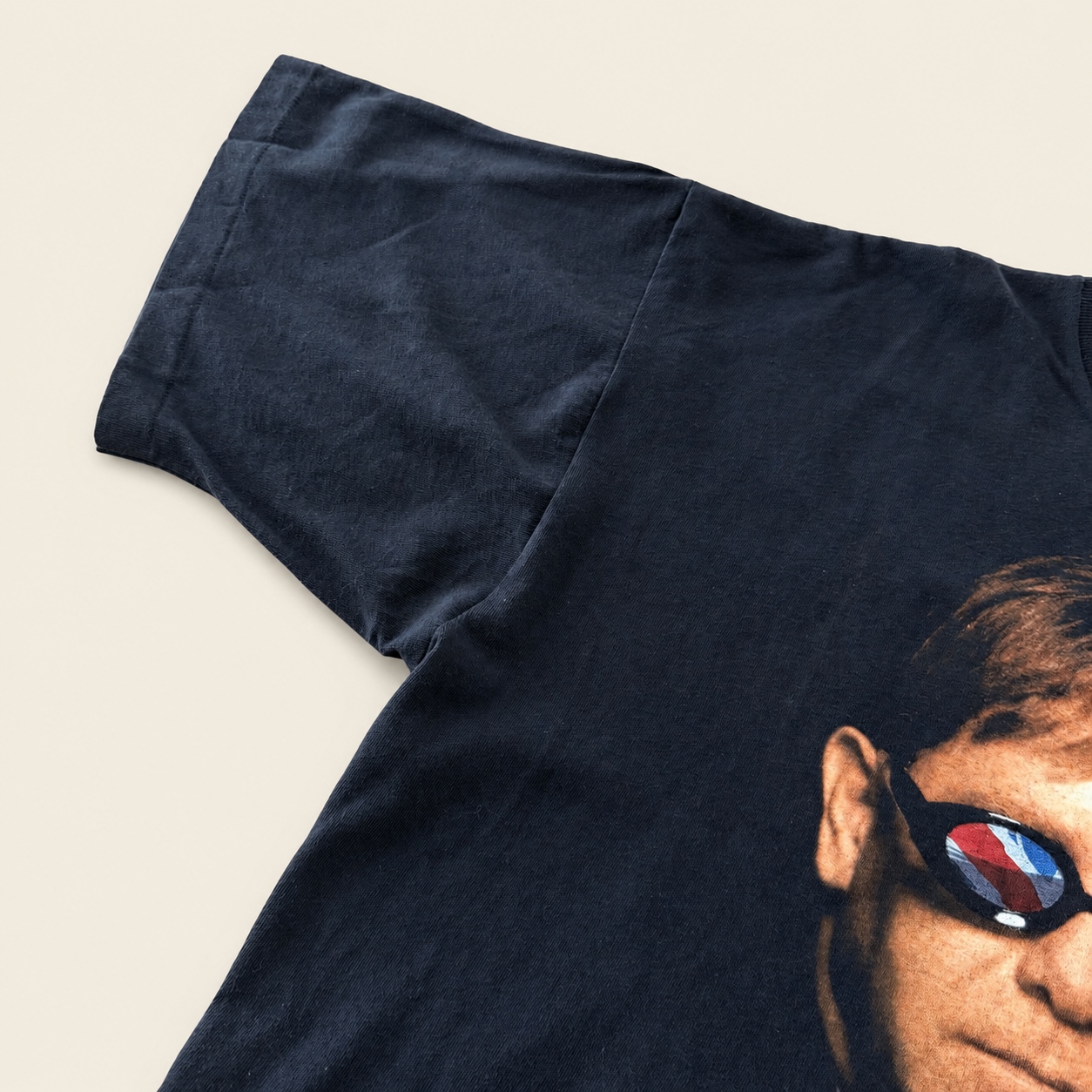 Left sleeve of Elton John Billy Joel 1994 all-over-print t-shirt, black heavyweight cotton