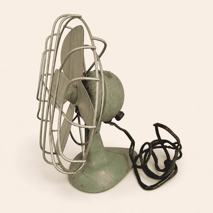 Vintage Faultless green desk fan, side profile view