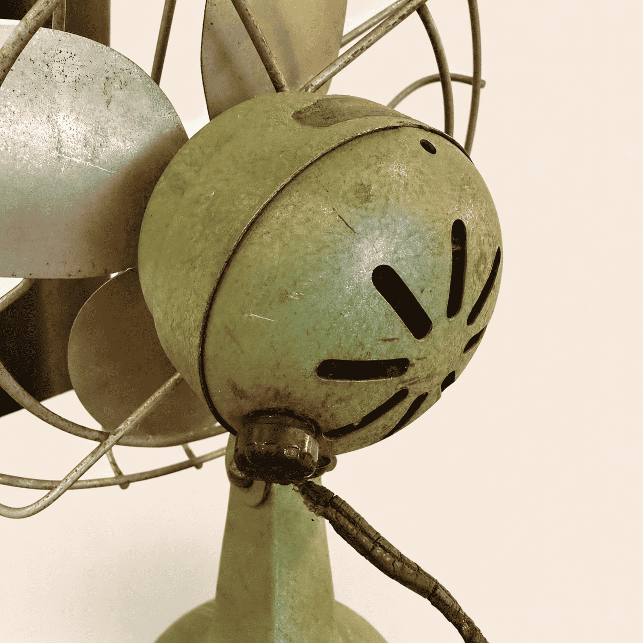 Close-up of the four steel blades and wire cage on the vintage Faultless fan