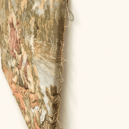 Raw unfinished edge of a vintage jacquard tapestry with loose threads