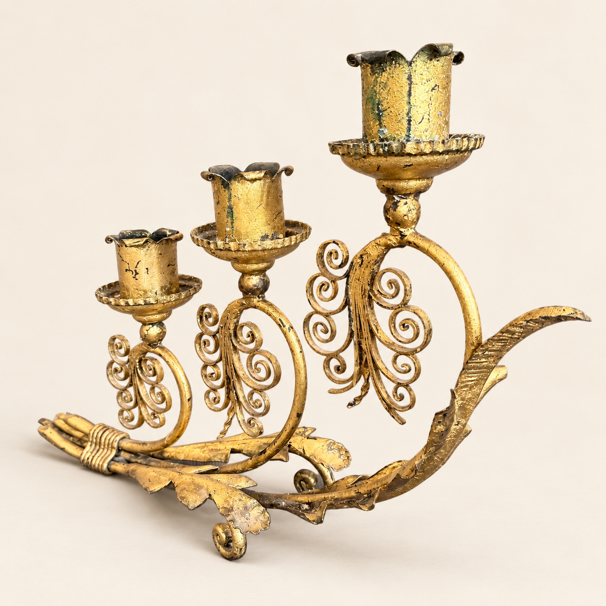 Vintage gilt tôle candelabra, angled view with feathered leaf detail