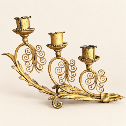 Gilt metal three-light candelabra, front view with scrolled flourishes