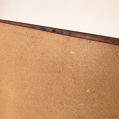 Edge detail of mirror back showing aged hardboard and staples