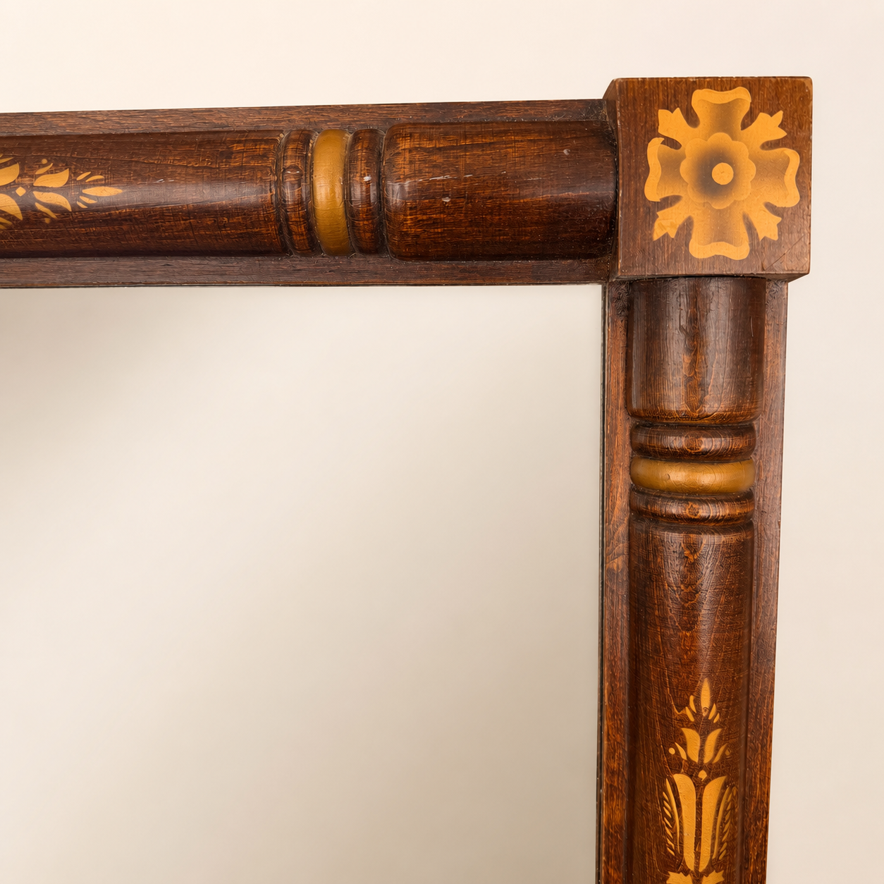 Corner detail of Hitchcock mirror showing painted rosette and gold column stenciling