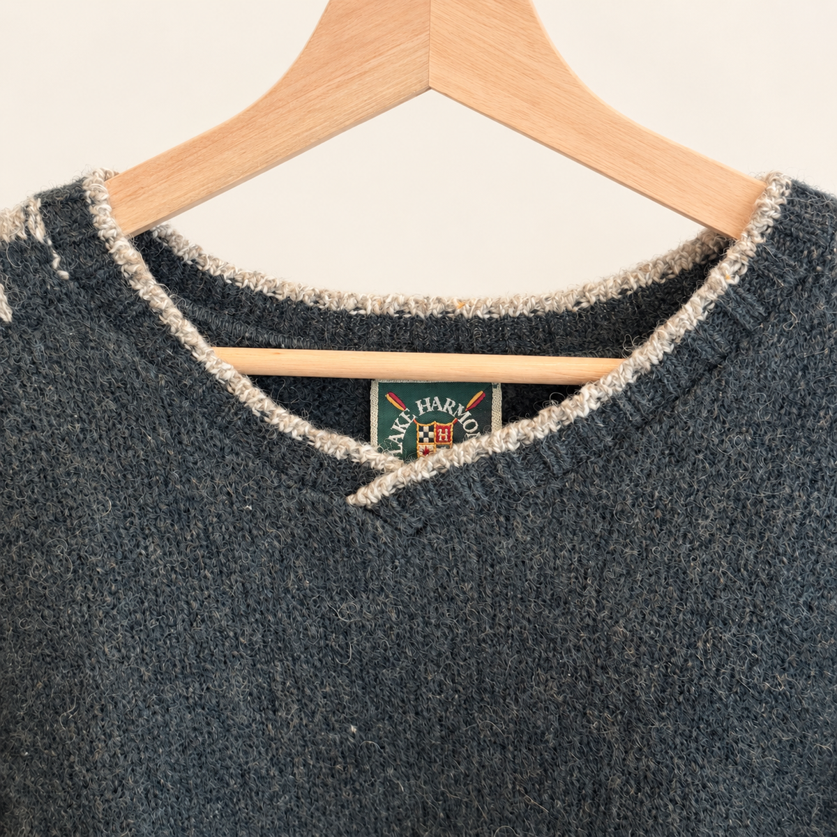 V-neckline and shoulder of green Nordic wool sweater