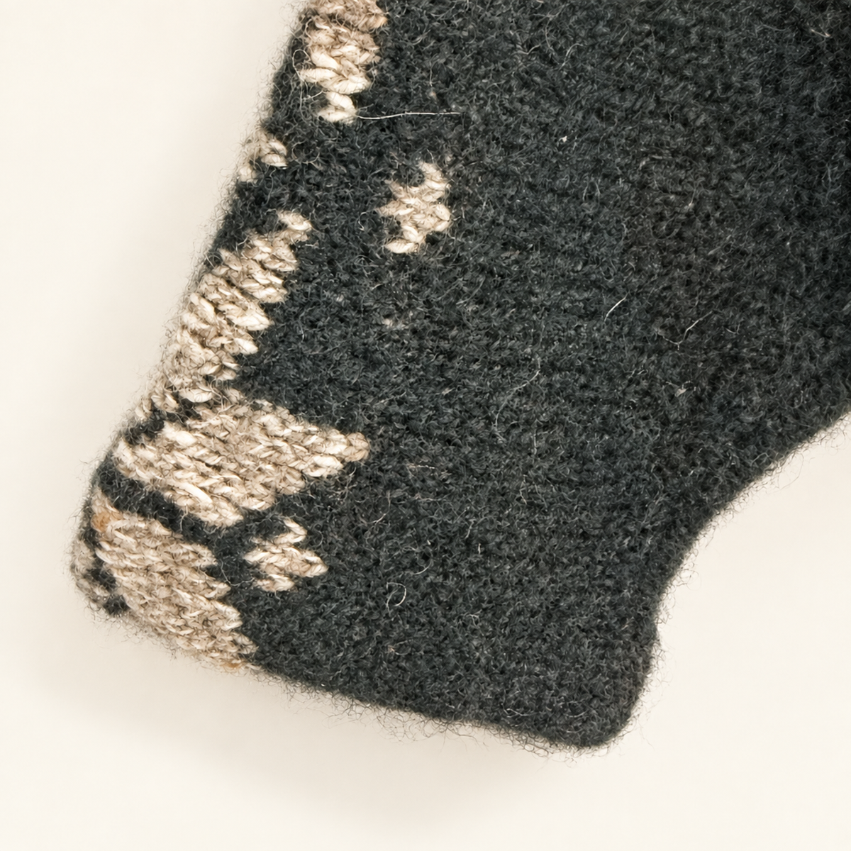 Cuff with snowflake pattern on vintage green wool sweater
