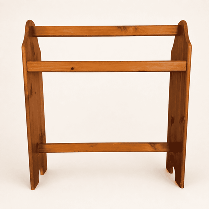 Vintage pine quilt rack with three rails and scalloped sides, front view