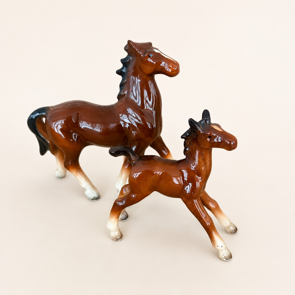Angled view of vintage Japanese porcelain horse figurine pair