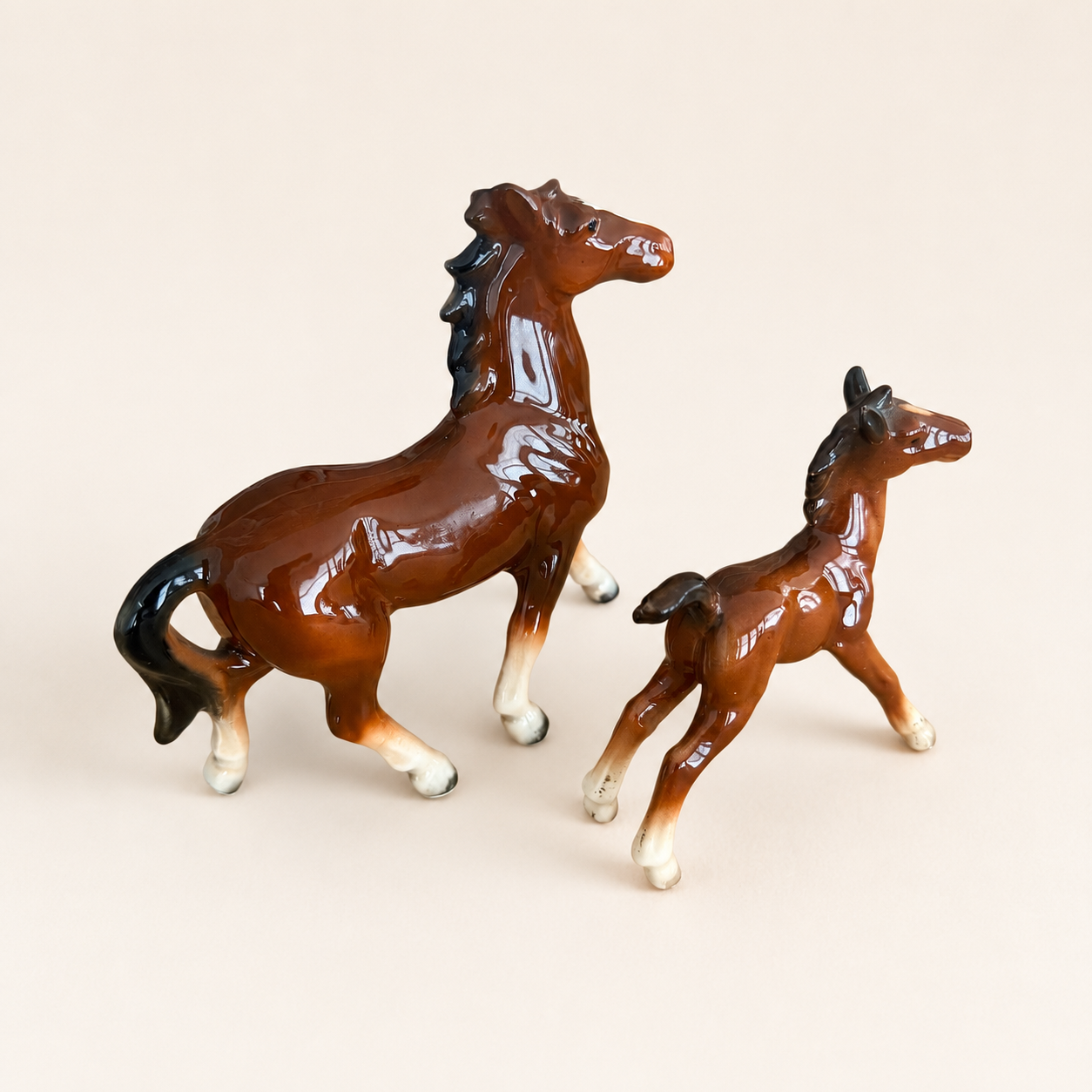 Three-quarter view of porcelain mare and foal figurines