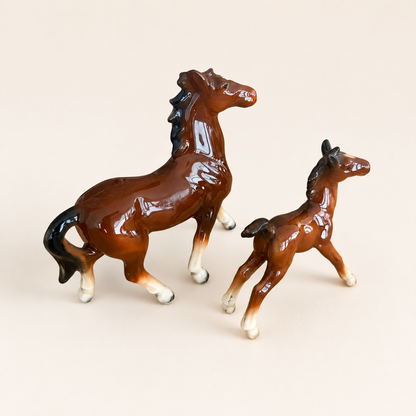 Three-quarter view of porcelain mare and foal figurines