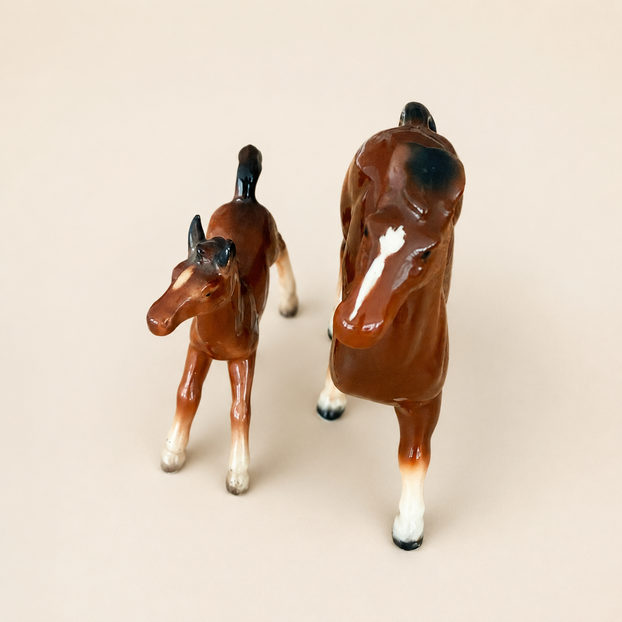 Front detail of porcelain horse figurines showing painted faces