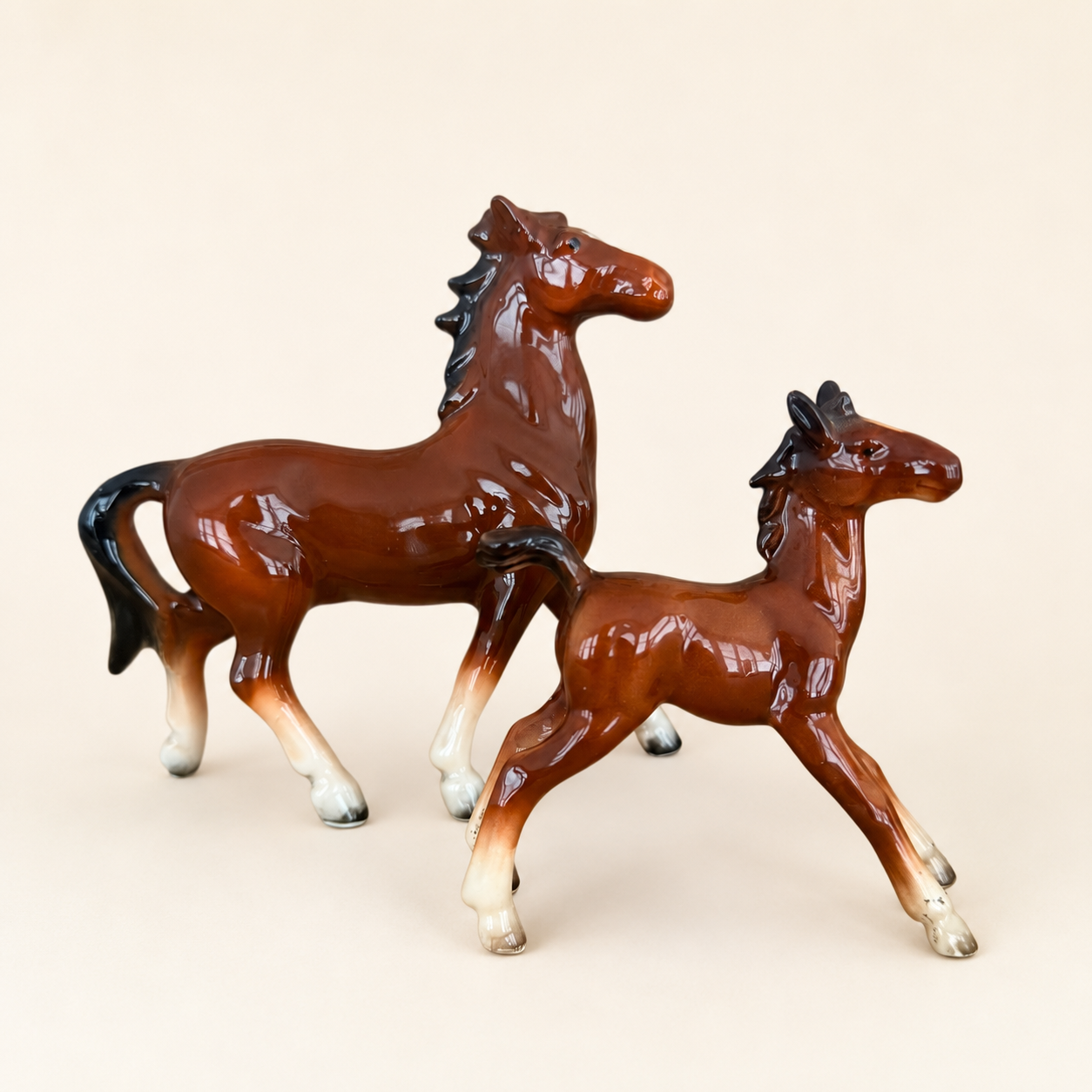 Vintage porcelain mare and foal horse figurines in glossy brown, front view