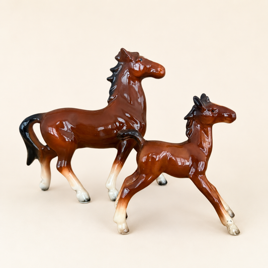 Vintage porcelain mare and foal horse figurines in glossy brown, front view