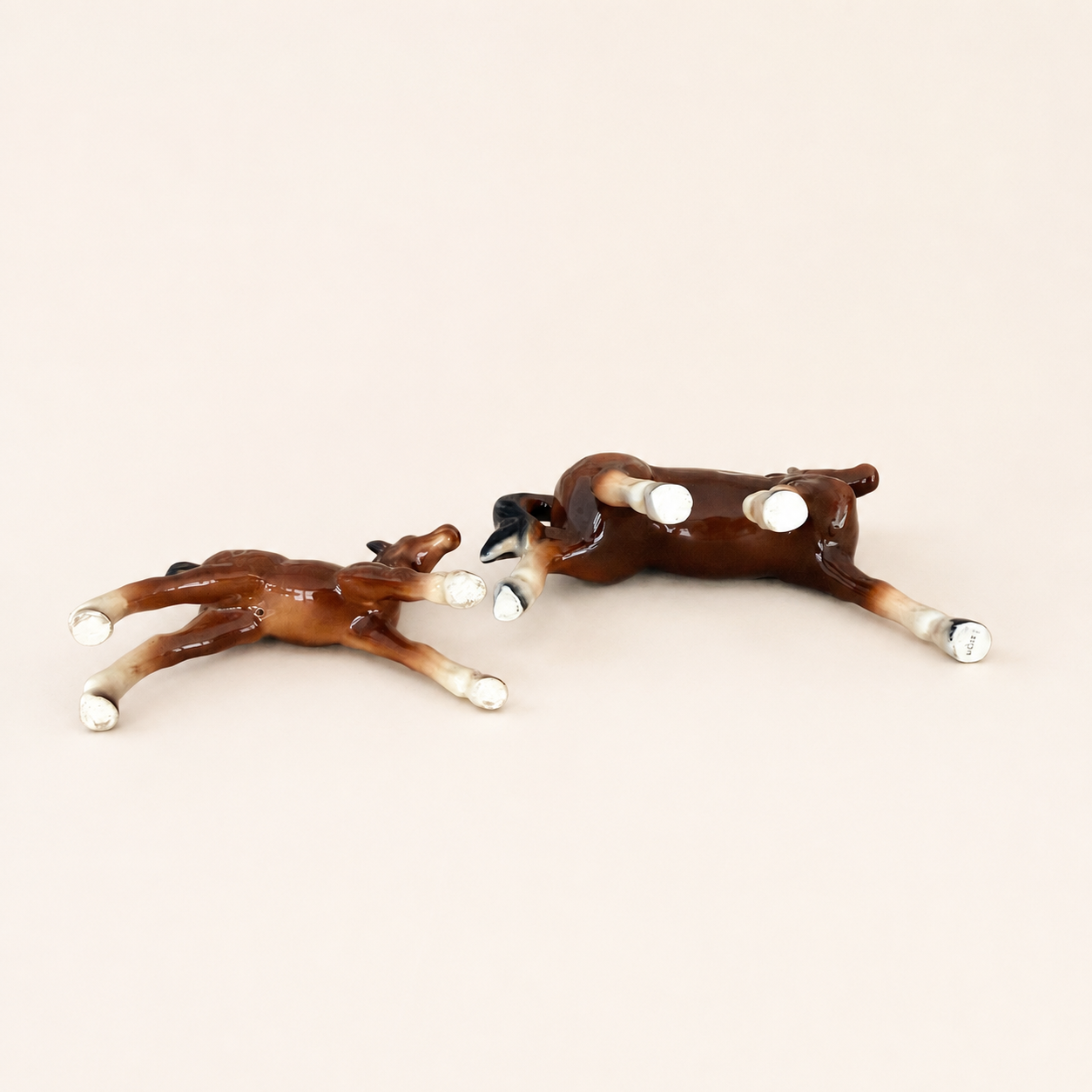 Underside of porcelain horse figurines showing legs and hooves