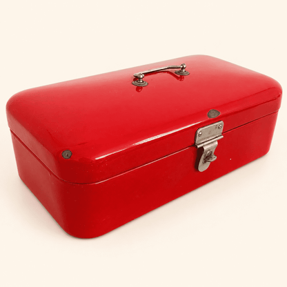 Front view of vintage red enamel bread box with domed lid