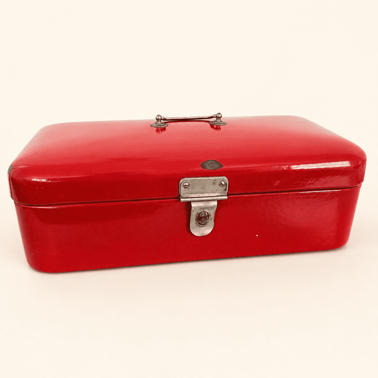 Vintage red enamel bread box with chrome handle and latch, three-quarter front view