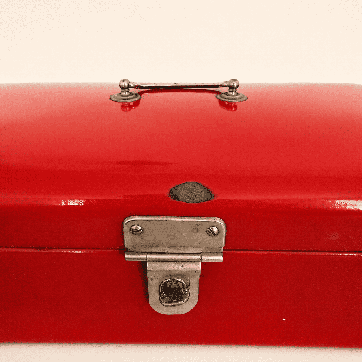 Detail of the chrome latch on the red enamel bread box