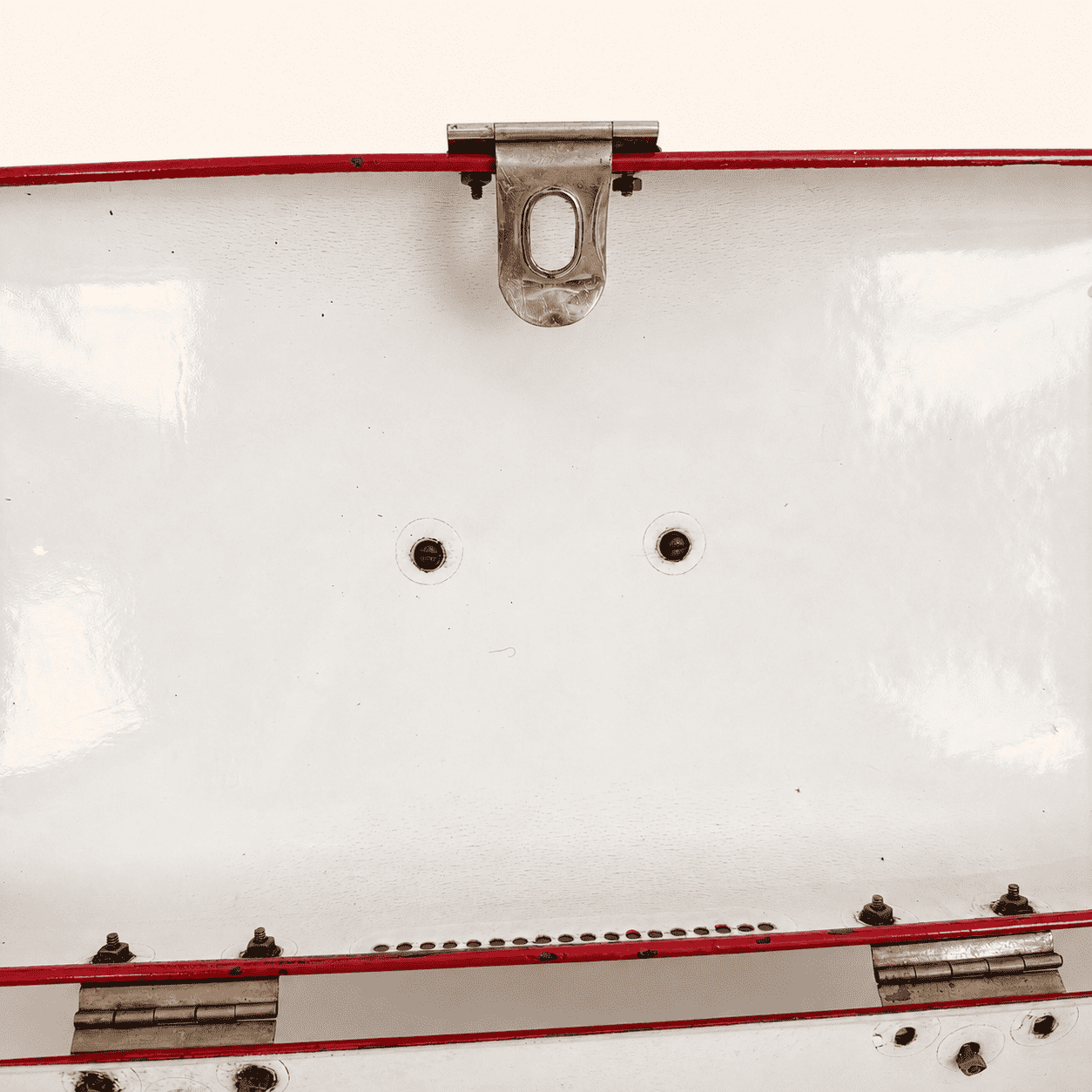 Interior of the lid showing hinge, latch catch, and mounting holes