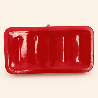 Underside of the red enamel bread box showing ribbed base