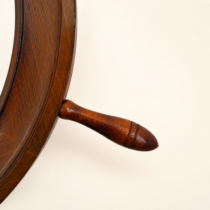 Detail of a turned wood spoke handle on the ship's wheel mirror