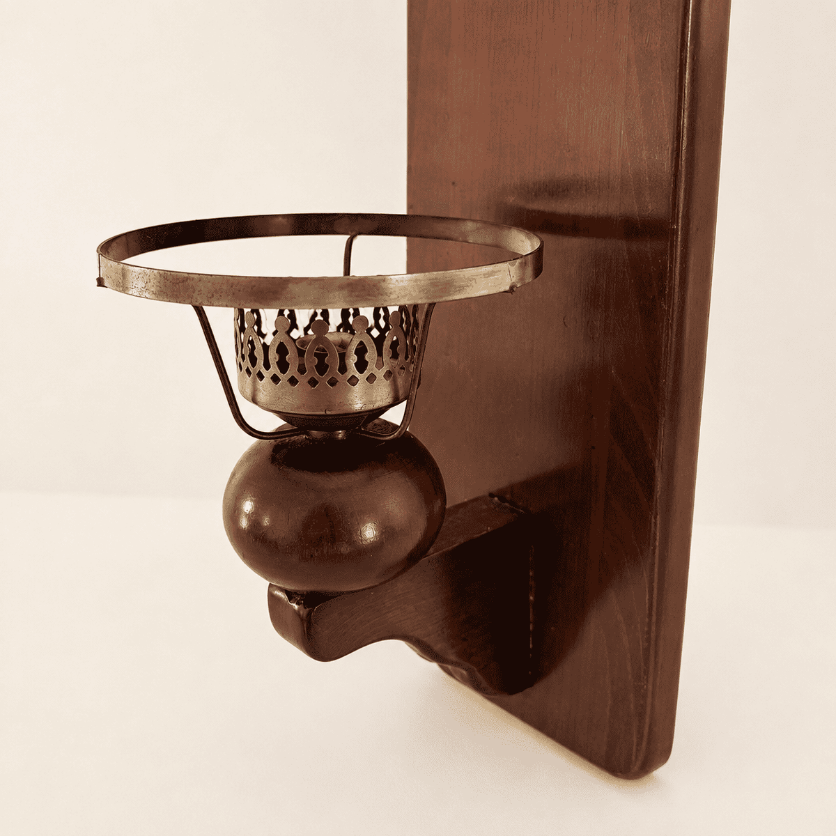 Side detail of the brass candle cup on the wood sconce