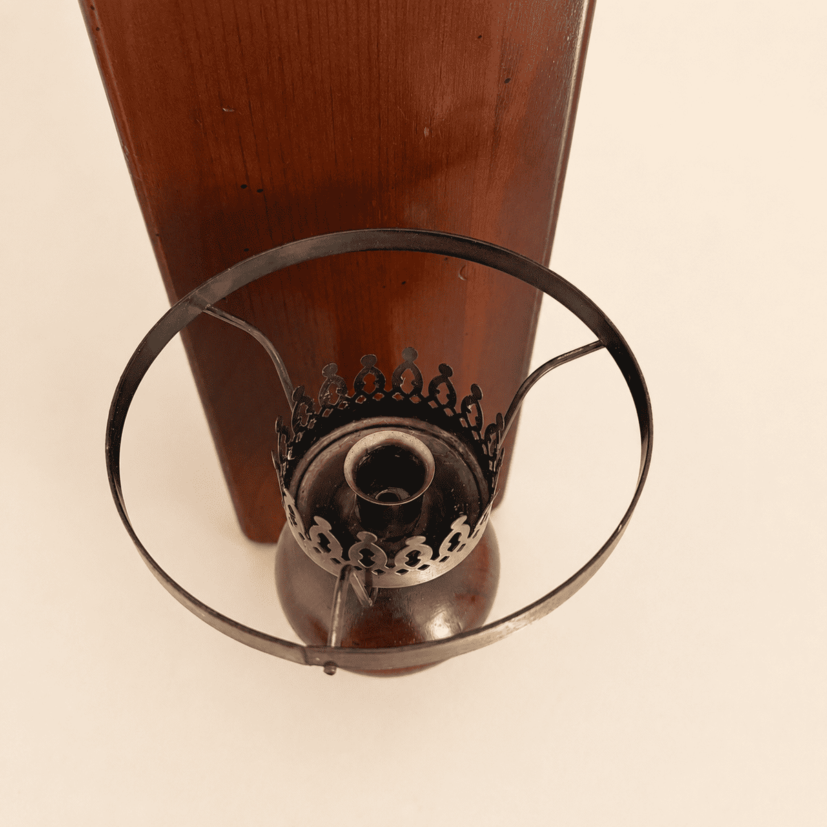 Top-down view into the brass candle cup and chimney ring
