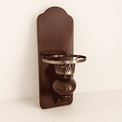 Vintage wood wall sconce candle holder with brass cup, three-quarter front view