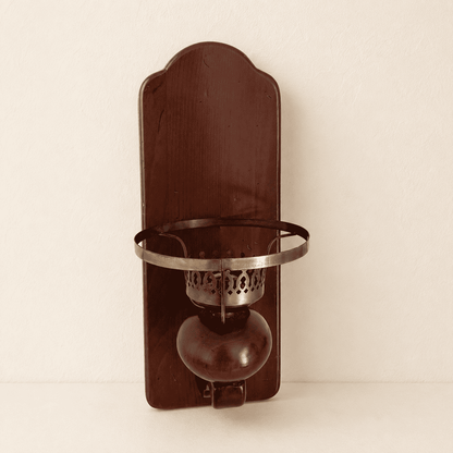 Front view of colonial wood wall sconce with pierced brass candle cup