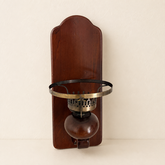 Front view of colonial wood wall sconce with pierced brass candle cup