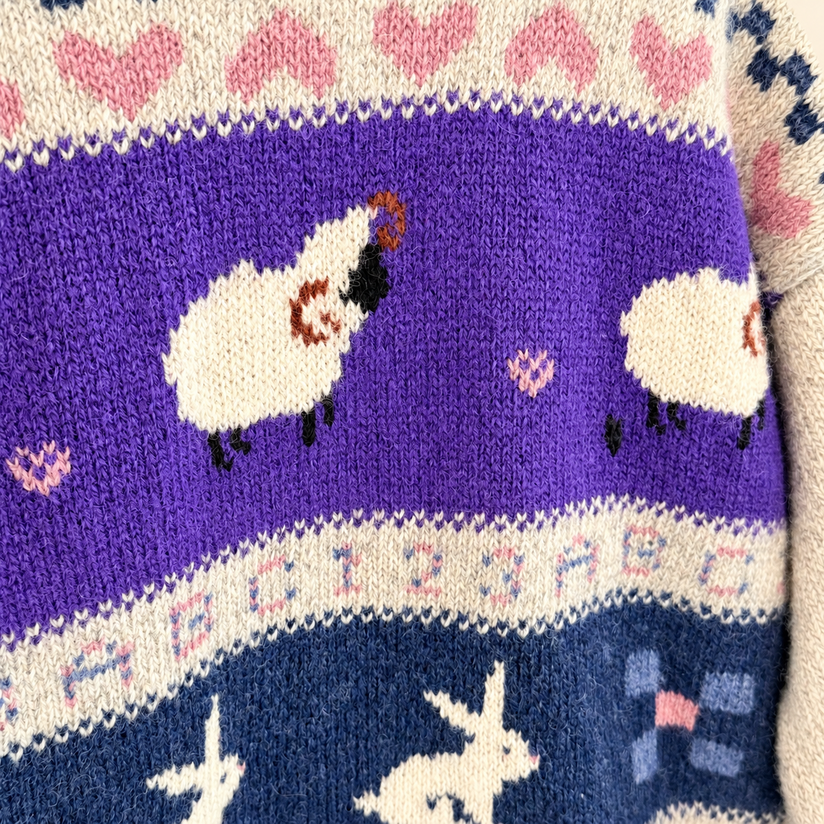 Purple band of sheep on vintage Woolrich wool sweater