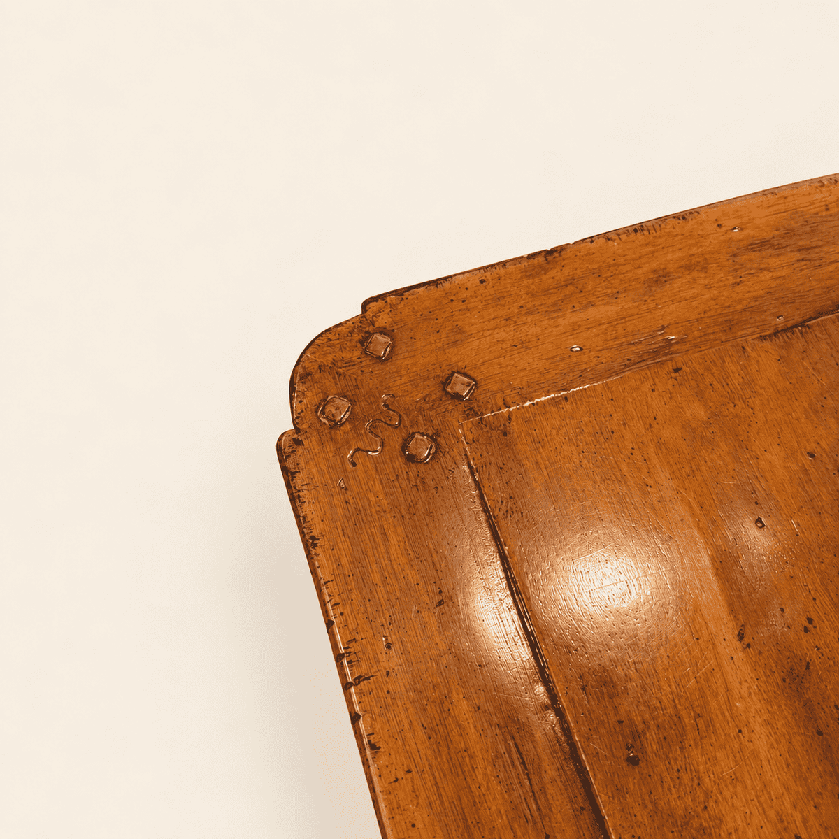 Corner detail of pegged breadboard end and hand-distressed walnut finish