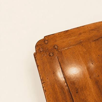 Corner detail of pegged breadboard end and hand-distressed walnut finish