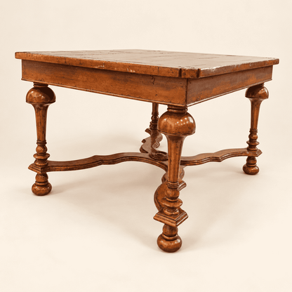 Side view of walnut coffee table showing inverted-cup legs and X-stretcher