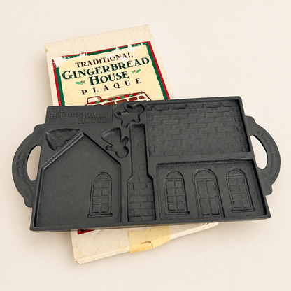 Cast iron gingerbread house baking mold with box, molded house pieces, top view