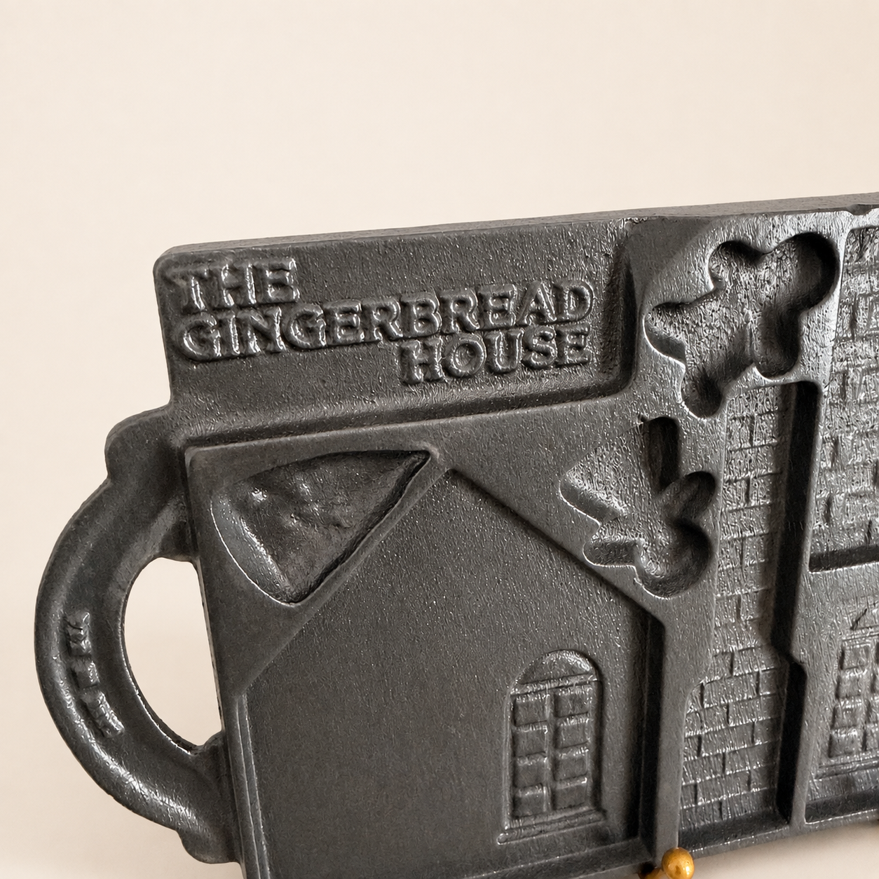 Detail of "The Gingerbread House" lettering and gingerbread man on the mold